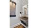 Unique powder room features custom stone sink and water feature at 1290 Pasadena Ne Ave, Atlanta, GA 30306