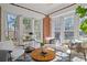 Cozy sunroom with lots of windows, comfortable seating, and natural light at 1290 Pasadena Ne Ave, Atlanta, GA 30306