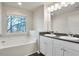 Bathroom with double vanity, soaking tub, and window at 161 Parkview Place Dr, Mcdonough, GA 30253