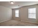 Well-lit bedroom with neutral walls and carpet at 161 Parkview Place Dr, Mcdonough, GA 30253