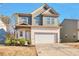 Two-story house with gray siding, white brick, and a two-car garage at 161 Parkview Place Dr, Mcdonough, GA 30253