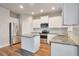 Modern kitchen with white cabinets, granite countertops, and stainless steel appliances at 161 Parkview Place Dr, Mcdonough, GA 30253
