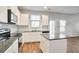 Modern kitchen with white cabinets, granite countertops, and stainless steel appliances at 161 Parkview Place Dr, Mcdonough, GA 30253