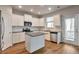 Modern kitchen with white cabinets, granite countertops, and stainless steel appliances at 161 Parkview Place Dr, Mcdonough, GA 30253
