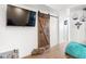 Basement features a sliding barn door and a large TV at 275 Trowbridge Ln, Lawrenceville, GA 30043