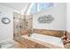 Bathroom with soaking tub, walk-in shower, and tiled walls at 275 Trowbridge Ln, Lawrenceville, GA 30043