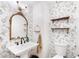 Stylish powder room with floral wallpaper and shelves at 275 Trowbridge Ln, Lawrenceville, GA 30043