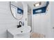 Small bathroom with white vanity, round mirror, and blue accent wall at 275 Trowbridge Ln, Lawrenceville, GA 30043