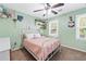 Bedroom with light green walls, ceiling fan, and queen bed at 275 Trowbridge Ln, Lawrenceville, GA 30043