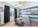 Bedroom with blue accent wall, ceiling fan and queen bed at 275 Trowbridge Ln, Lawrenceville, GA 30043