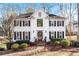 Two-story white house with black shutters and a manicured lawn at 275 Trowbridge Ln, Lawrenceville, GA 30043