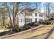 Two-story white house with black shutters, landscaping, and a paved pathway at 275 Trowbridge Ln, Lawrenceville, GA 30043