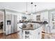 Kitchen boasts granite island, white cabinets, and stainless steel appliances at 275 Trowbridge Ln, Lawrenceville, GA 30043