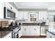 Kitchen with white cabinets, granite countertops, and stainless steel appliances at 275 Trowbridge Ln, Lawrenceville, GA 30043