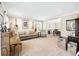 Living room with a piano, sofa, and view into dining area at 275 Trowbridge Ln, Lawrenceville, GA 30043