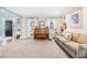 Spacious living room featuring a piano, comfortable sofa, and large windows at 275 Trowbridge Ln, Lawrenceville, GA 30043