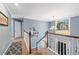 View from upstairs hallway overlooking the entryway and front door at 275 Trowbridge Ln, Lawrenceville, GA 30043