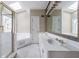 Bathroom with double vanity, large mirror, and jetted tub at 228 Spalding Gates Dr, Atlanta, GA 30328