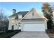 Two-story house with stucco siding, a white door, and a two-car garage at 228 Spalding Gates Dr, Atlanta, GA 30328