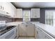 Bright eat-in kitchen with white cabinets and modern appliances at 228 Spalding Gates Dr, Atlanta, GA 30328