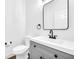 Updated bathroom with gray vanity, black matte fixtures, and white subway tile at 3110 Haverhill Ne Cv, Conyers, GA 30012