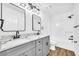 Modern bathroom with double vanity, marble countertop, and updated fixtures at 3110 Haverhill Ne Cv, Conyers, GA 30012