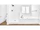 Clean bathroom with soaking tub, shower, and hardwood floors at 3110 Haverhill Ne Cv, Conyers, GA 30012