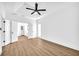 Spacious bedroom with hardwood floors, ceiling fan and access to additional rooms at 3110 Haverhill Ne Cv, Conyers, GA 30012