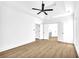 Large bedroom with hardwood floors, a ceiling fan and access to bathroom at 3110 Haverhill Ne Cv, Conyers, GA 30012