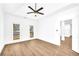 Spacious bedroom with hardwood floors, ceiling fan and access to hallway at 3110 Haverhill Ne Cv, Conyers, GA 30012