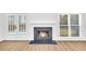 Modern fireplace with white mantel and hardwood floors at 3110 Haverhill Ne Cv, Conyers, GA 30012