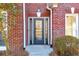 Gray front door with glass accents at 3110 Haverhill Ne Cv, Conyers, GA 30012