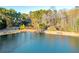 Peaceful lakefront view with benches and trees at 3110 Haverhill Ne Cv, Conyers, GA 30012