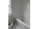 Bathroom with white subway tile in shower/bath, a toilet, and marble floors at 5043 Baywood Ln, Woodstock, GA 30188