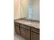 Bathroom vanity with granite countertop, ample cabinet space, and a large mirror at 5043 Baywood Ln, Woodstock, GA 30188