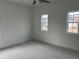 This bedroom offers natural light from two windows and plush carpeting at 5043 Baywood Ln, Woodstock, GA 30188