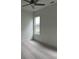 Bright bedroom features a ceiling fan, neutral carpet, and a view from a window at 5043 Baywood Ln, Woodstock, GA 30188