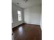 Bright bedroom with hardwood floors, neutral walls, and a double-hung window at 5043 Baywood Ln, Woodstock, GA 30188