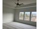 Carpeted main bedroom with a ceiling fan and view from multiple windows at 5043 Baywood Ln, Woodstock, GA 30188