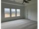 Carpeted bedroom with a ceiling fan, view from multiple windows and a closet at 5043 Baywood Ln, Woodstock, GA 30188