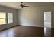 Spacious bedroom features hardwood flooring, a ceiling fan, and natural light from windows at 5043 Baywood Ln, Woodstock, GA 30188