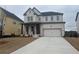 Charming two-story home with brick exterior, covered porch, and two-car garage at 5043 Baywood Ln, Woodstock, GA 30188