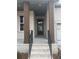 Front porch of home has brick columns, black railings, and a brick staircase at 5043 Baywood Ln, Woodstock, GA 30188
