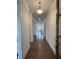 Long hallway with hardwood floors, white walls, and a view of the staircase at 5043 Baywood Ln, Woodstock, GA 30188
