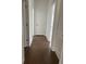 Hallway with rich hardwood floors and white doors leading to various rooms at 5043 Baywood Ln, Woodstock, GA 30188