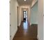 Entryway hall with hardwood floors, white walls, and glass-paneled front door at 5043 Baywood Ln, Woodstock, GA 30188