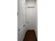 Hallway featuring hardwood floors and doors leading to storage at 5043 Baywood Ln, Woodstock, GA 30188