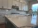 Kitchen with island, quartz countertops, chevron backsplash, and stainless steel appliances at 5043 Baywood Ln, Woodstock, GA 30188