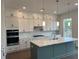 Modern kitchen with island, white cabinetry, stainless appliances, and tile backsplash at 5043 Baywood Ln, Woodstock, GA 30188