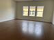 Bright living room featuring gleaming hardwood floors and a window view at 5043 Baywood Ln, Woodstock, GA 30188